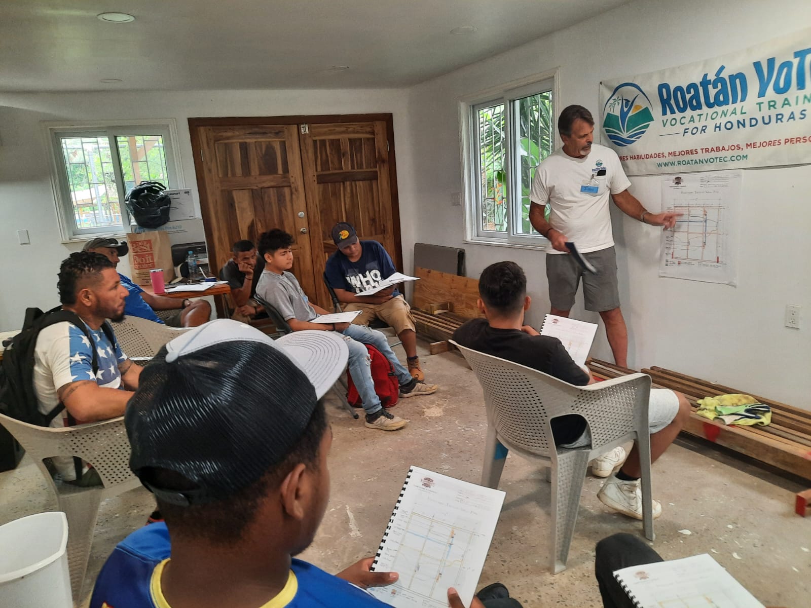 RVT instructor teaching students from blueprints in the Sandy Bay campus classroom