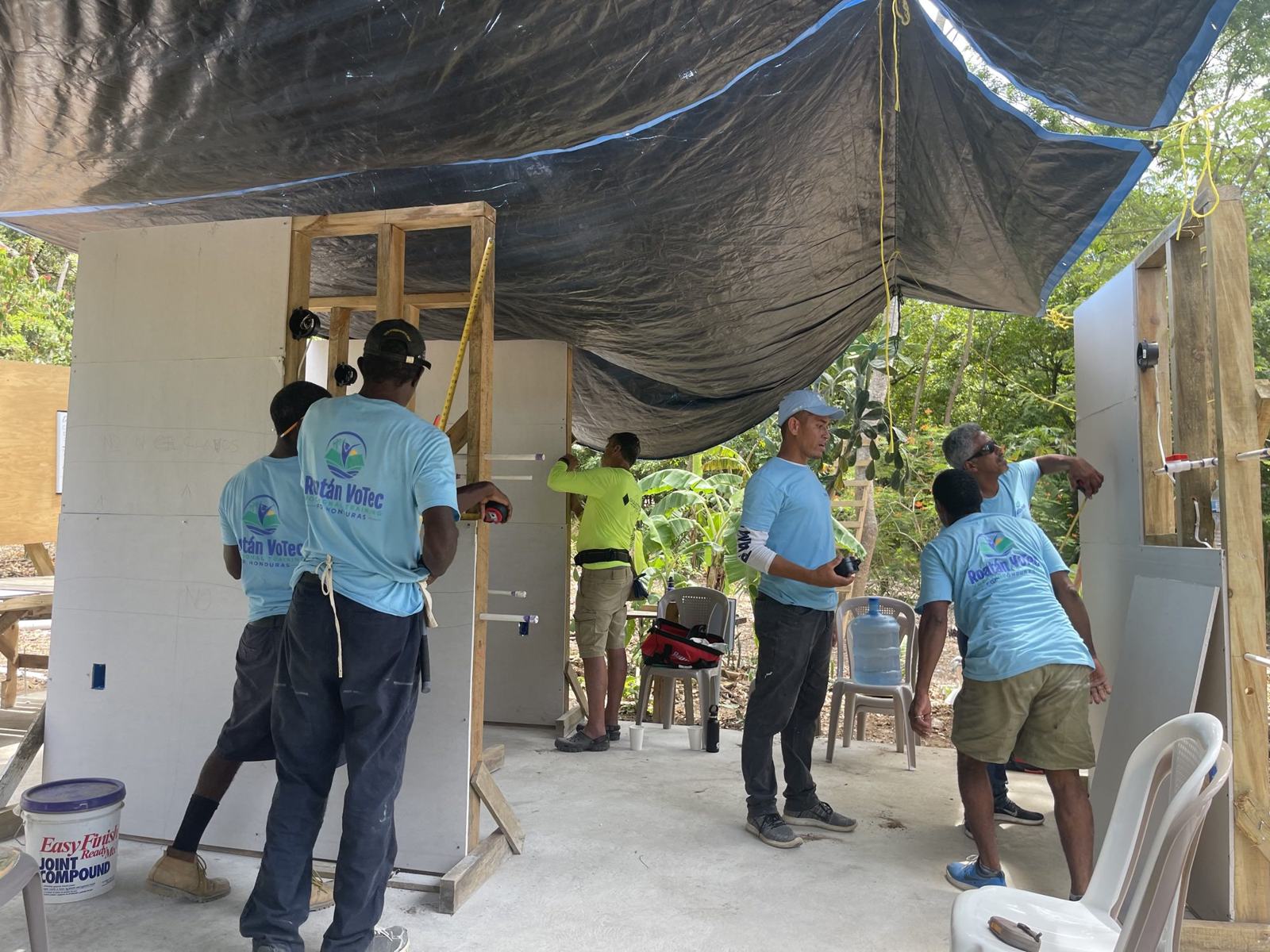 Students installing drywall